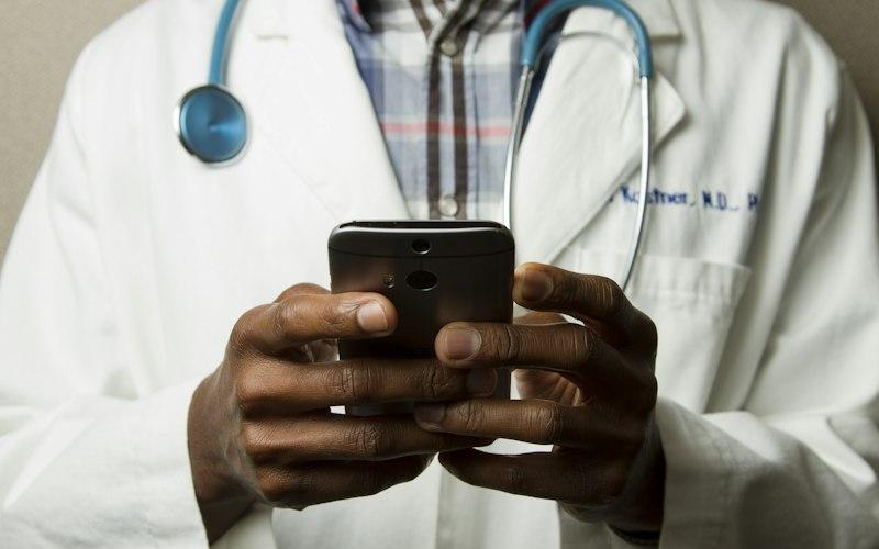 Healthcare professional using a phone for care coordination